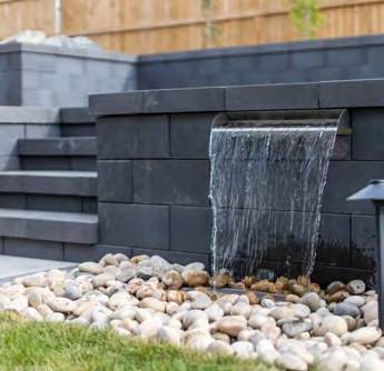 Stone retaining wall with a built in water feature